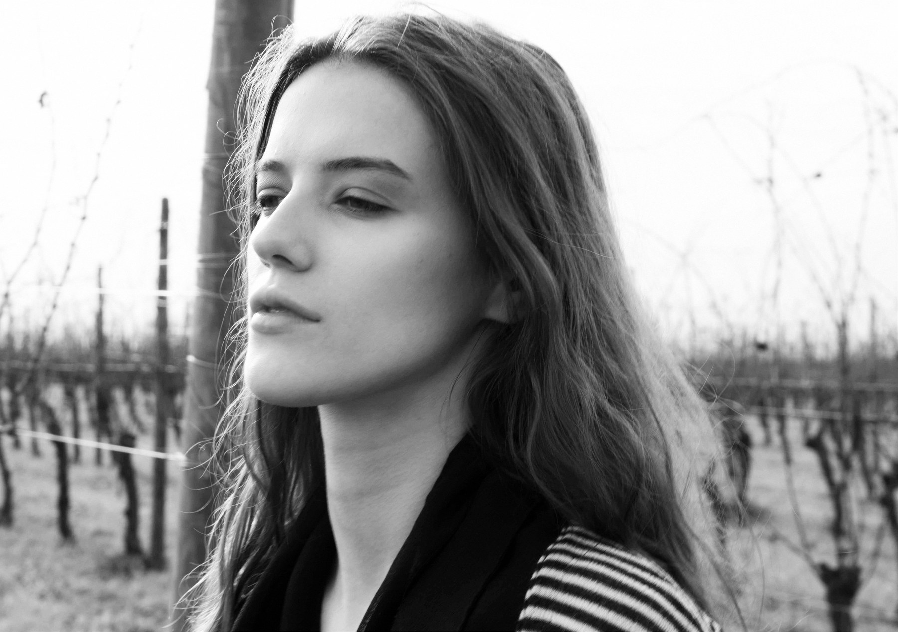 Portrait in the vineyard, striped knit and black scarf