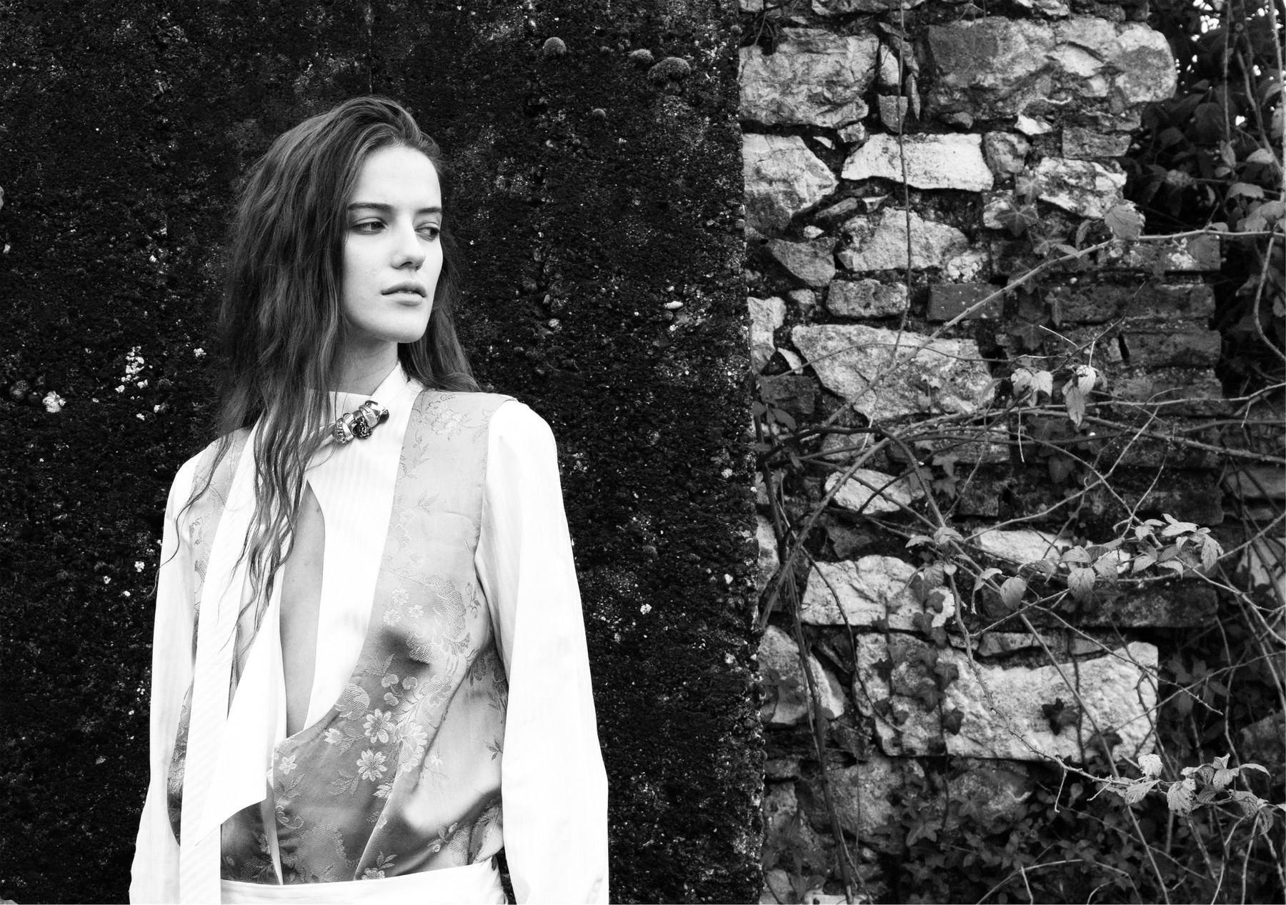 Shirt and brocaded satin vest against a dry stone wall