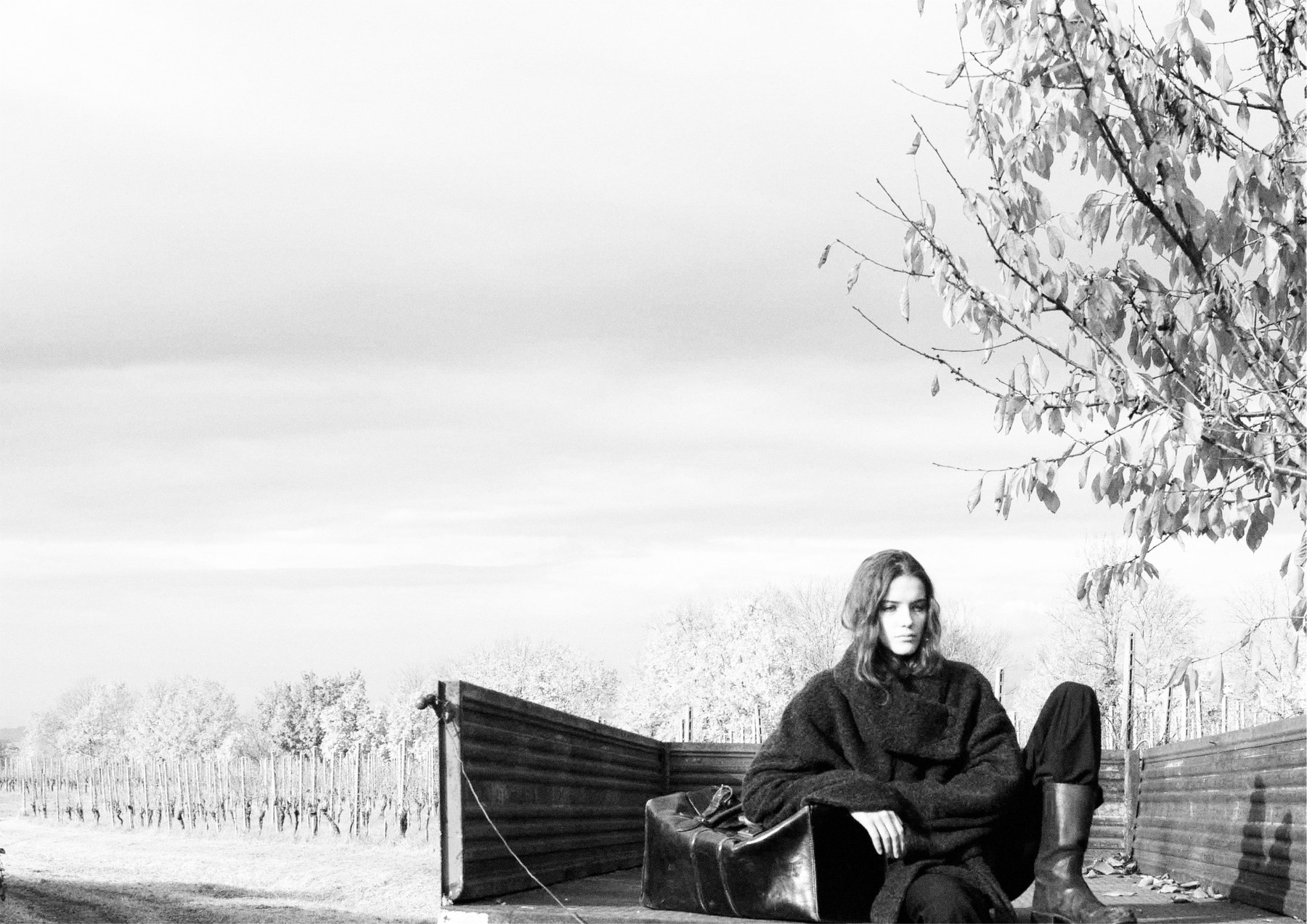 Seated on a farm cart at the edge of the field