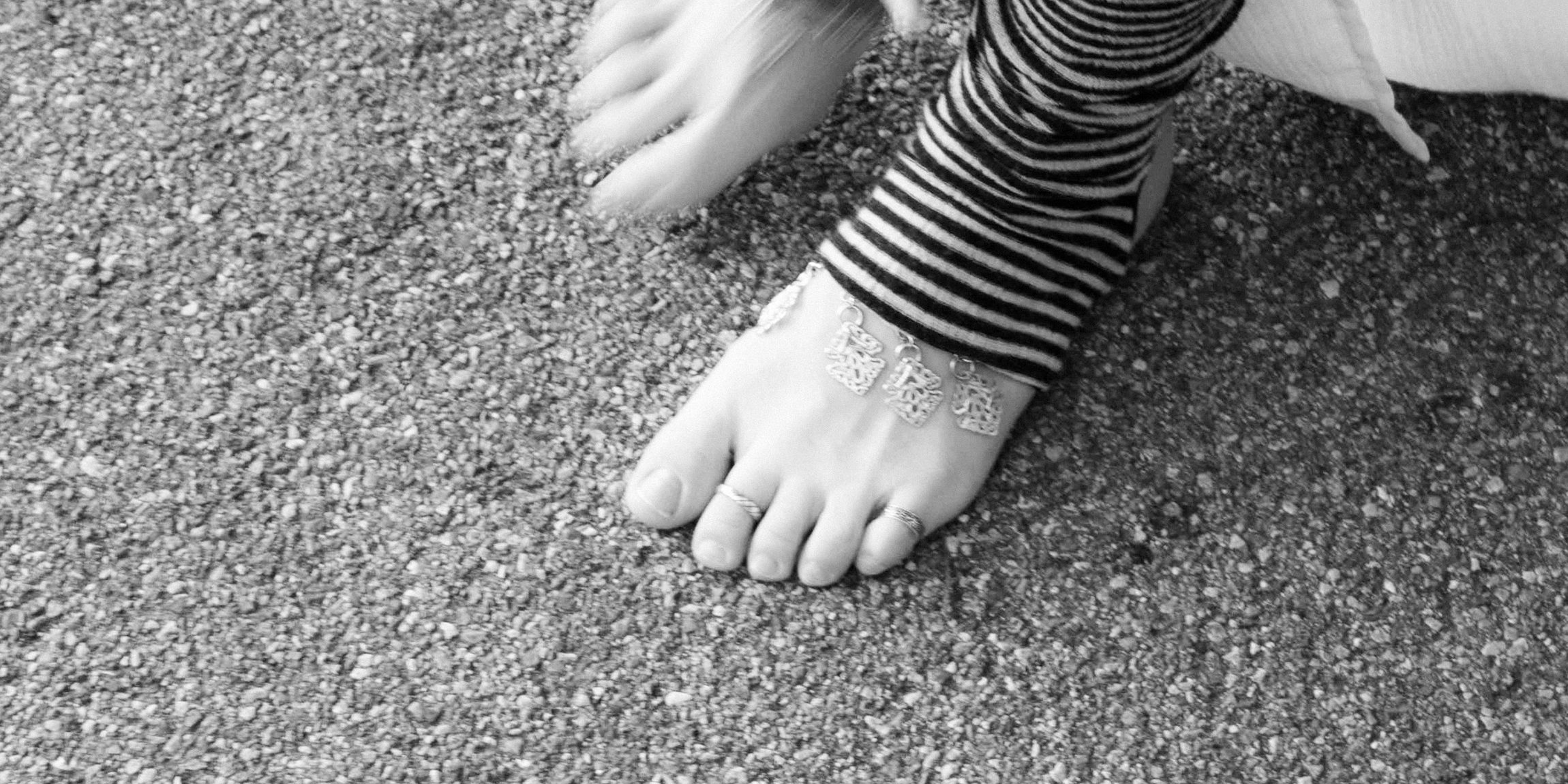 Bare feet on gravel, mid foot cut tights