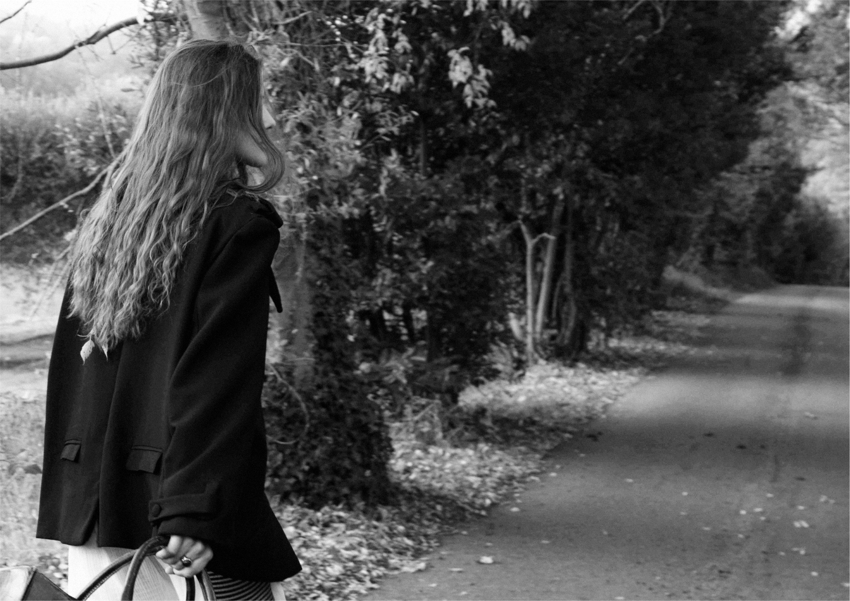 From behind on a tree lined road, oversized blazer